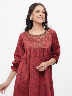 Maroon all-over printed woven top in Crepe fabric. Designed with a round neck and bishop sleeves. Embellished with karchupi and pleats at the front. Single button opening at the back. Unlined.