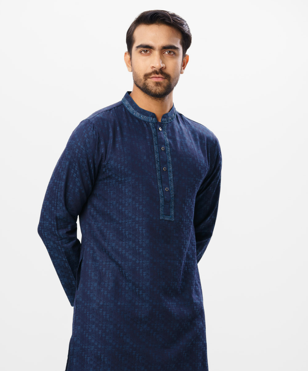 Blue Semi Fitted Jacquard Panjabi Blue semi-fitted Panjabi in Jacquard Cotton fabric. Designed with minimal karchupi on the collar and placket.