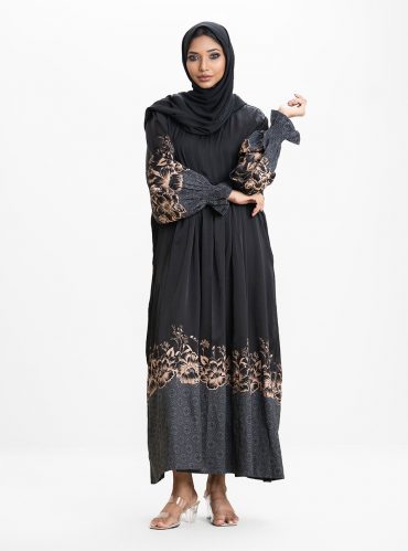 Women's gown style abaya in crepe fabric. Round neck, bishop sleeves. Box pleated waistline. Karchupi and print detail at sleeves and hemline.
